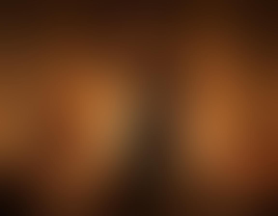 A romantic setting with a couple in a cozy, intimate atmosphere, surrounded by soft candlelight and rich textiles, expressing affection and sensuality. Incorporate elements like sensual silhouettes, delicate floral arrangements, and playful, intertwined hands. The background should evoke warmth and intimacy with subtle hints of passion. super-realistic. warm tones. softly blurred background.